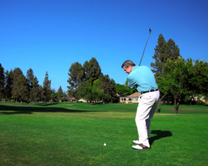 A golfer swinging their club